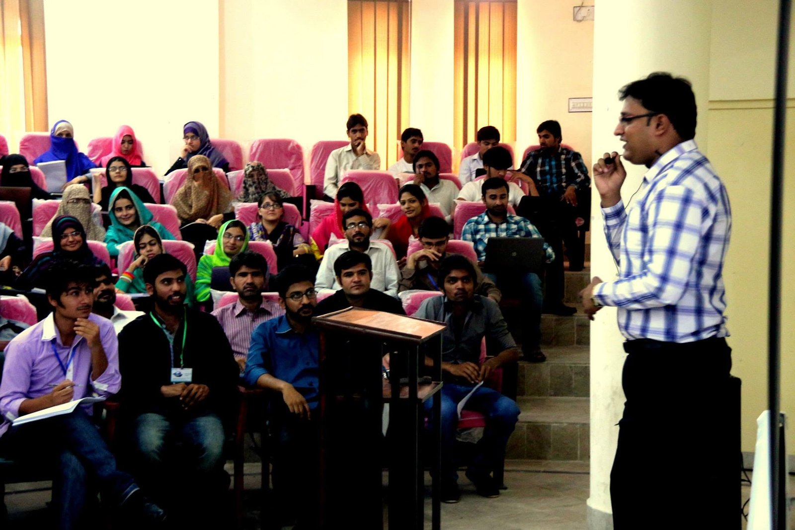 Ghulam Sarwar addressing an audience during a training session